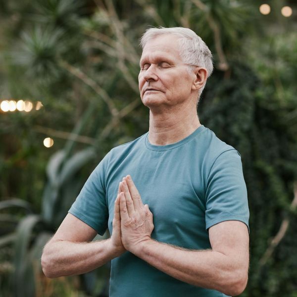 Man meditating peacefully after a workout session, showing focus and calm.